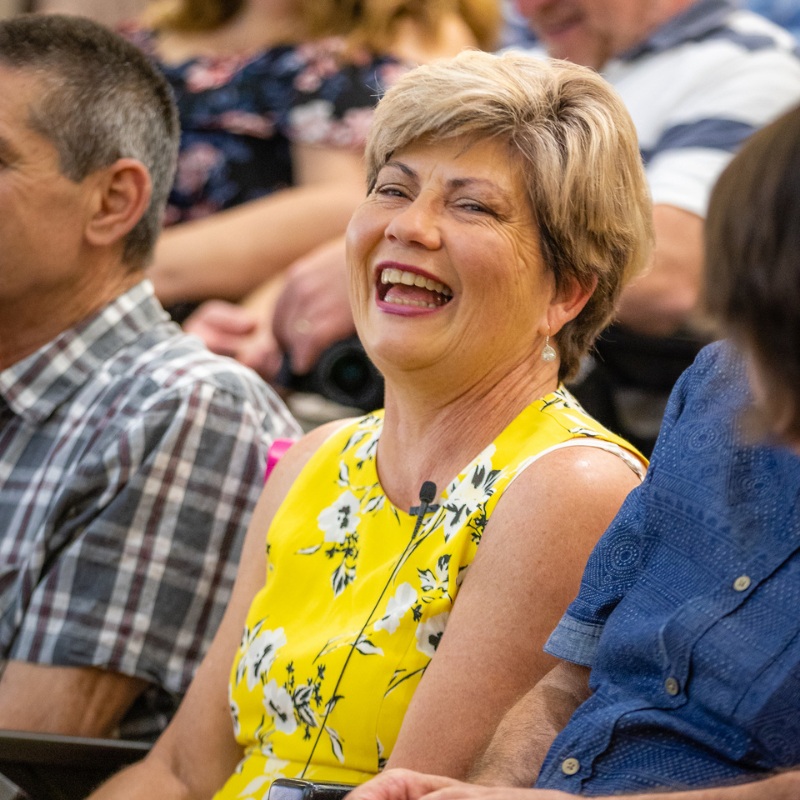 Colleen laughing as part of the audience at the book launch.