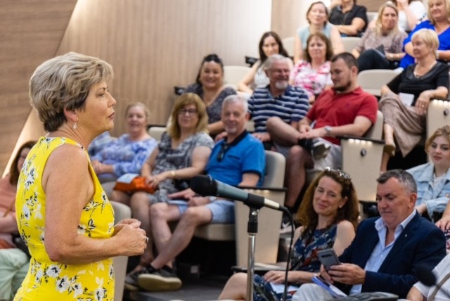 Colleen in front of a crowd explaining lifes opportunities.