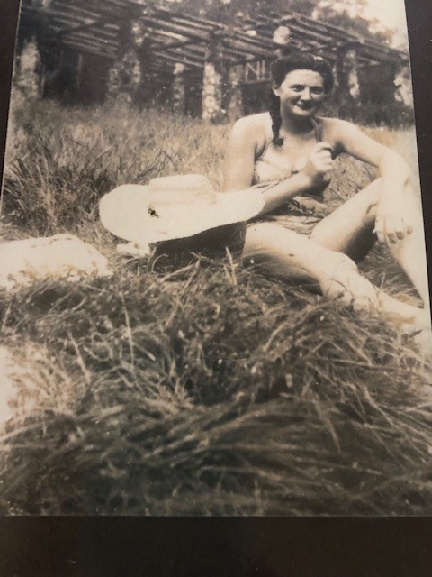 Black and white picture of colleens mum having a picnic in the tall grass