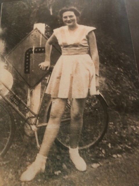 Lovely black and white picture of Colleens mum standing next to a bycicle