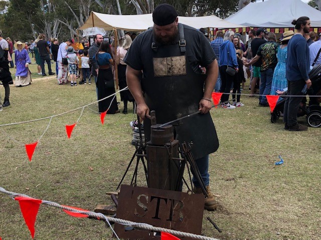 Guildford Medieval festival Blacksmith making iron wares.