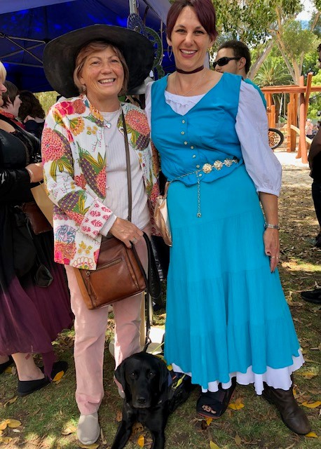 Picture of Colleen at the Medieval festival of Guildford,standing next to a beautifull lady in a medival styl turqoise dress.