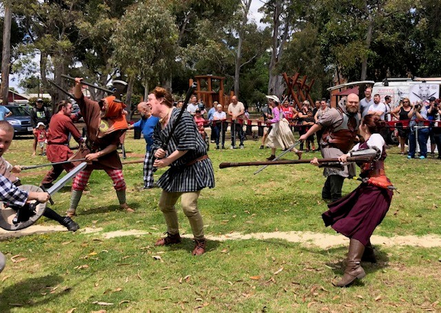 PIcture of a batlle scene with people in sword fight at the Guildford Medieval festival.