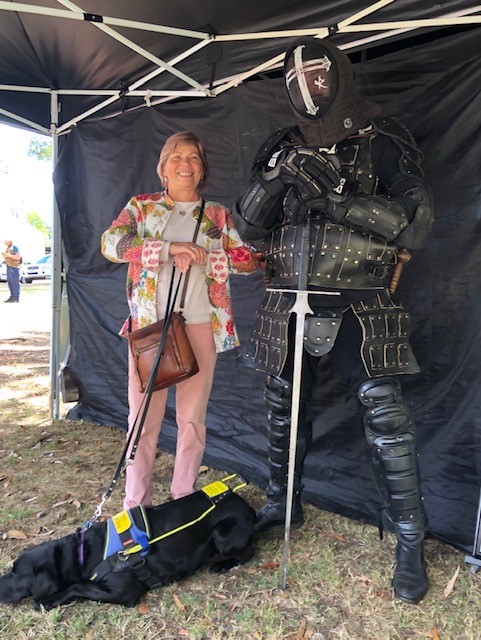 PIcture of Colleen next to a huge black knight in leather costume at the Guildford Medieval festival.