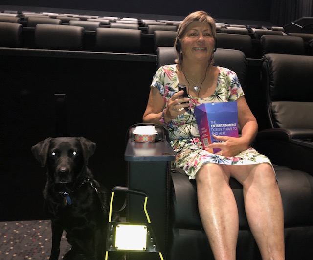 Colleen and Rhian sitting a comfortable chair eating popcorn and enyoing a movie.