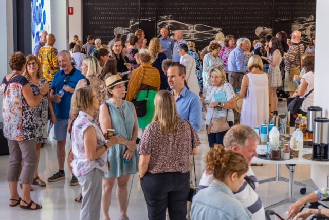 Photo of the lobby with lots of people before the book launch of a Blind heart transplant recipient. Colleen Ashby