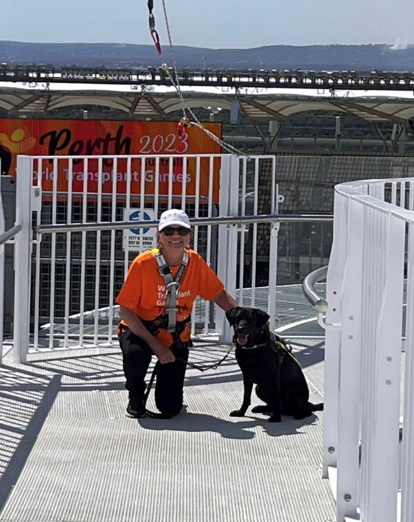 Picture of Colleen and dog Rhian high above Optus Stadium in harness about to go on the Vertigo Challenge.